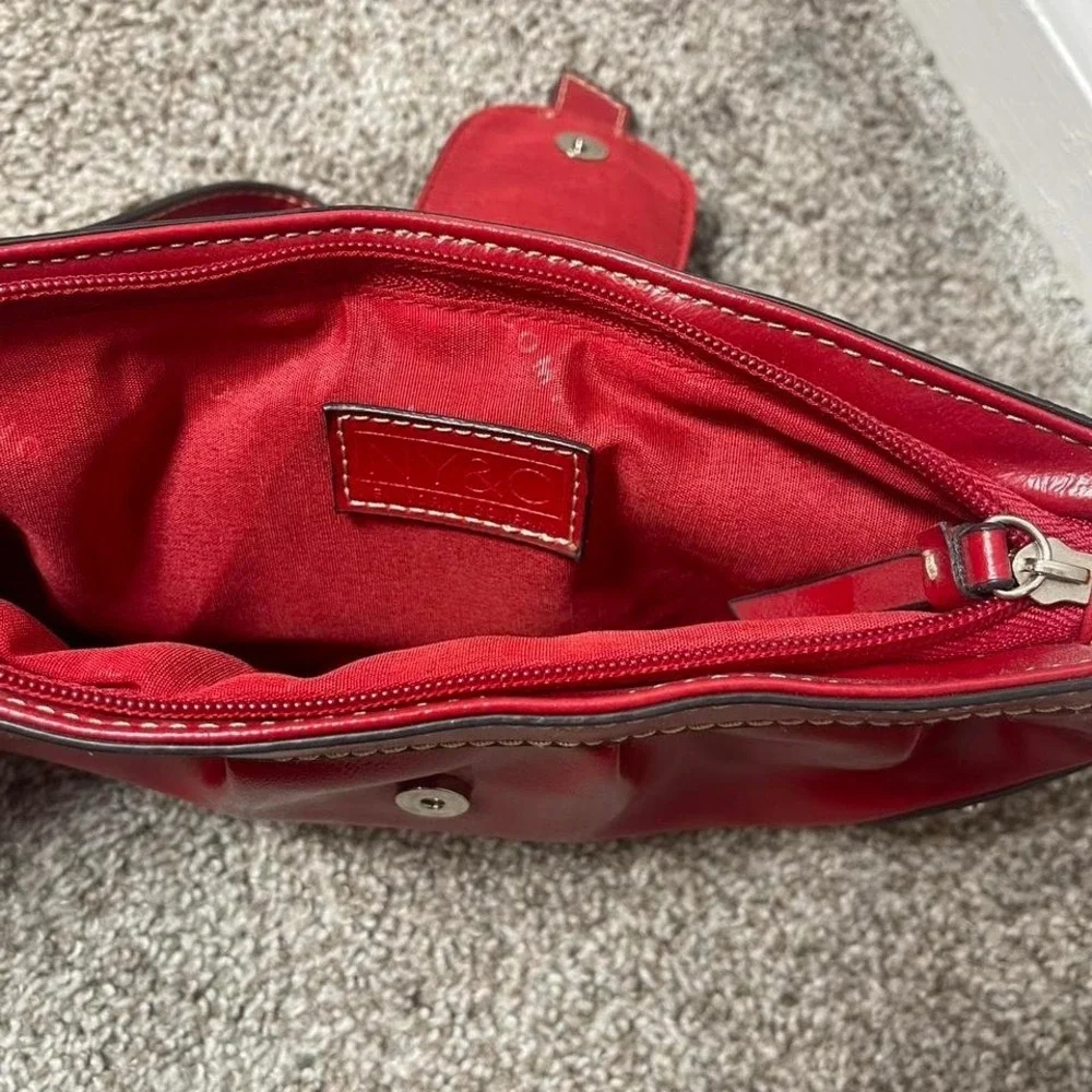 Red leather clutch handbag with silver hardware